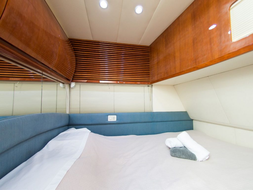 spacious sleeping space with comfortable bed and a lot of wardrobe compartments