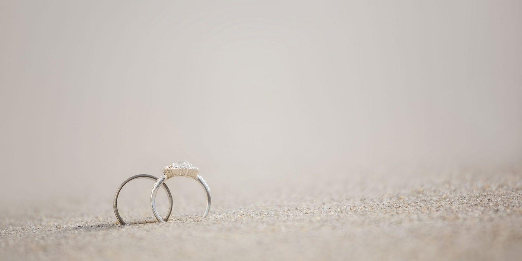 Two wedding rings in the sand