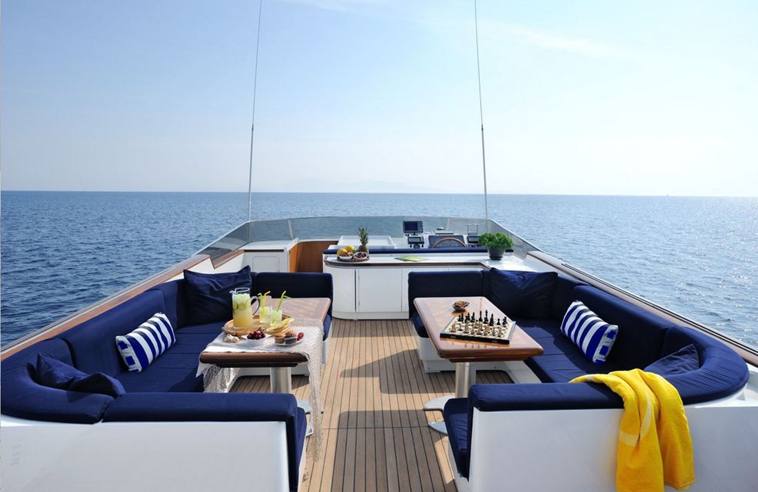 A deck of a luxury yacht with two tables