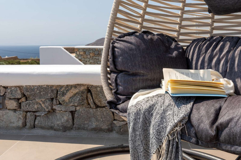 Enjoy reading outside of the best private home for rent in Mykonos, Greece.
