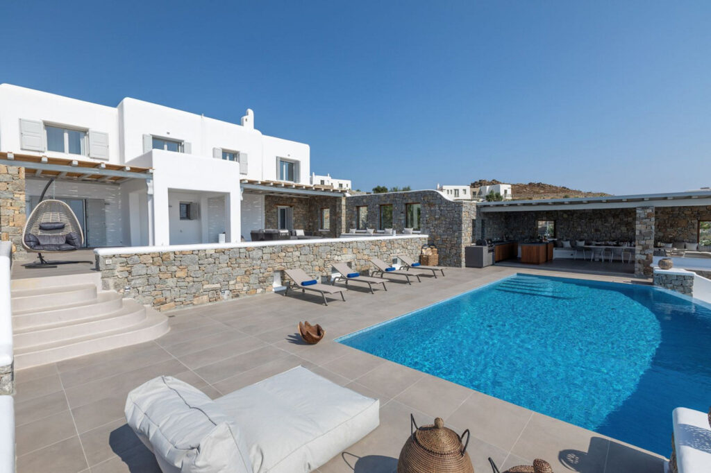 Spacious garden with a luxurious swimming pool in Mykonos villa for rent.