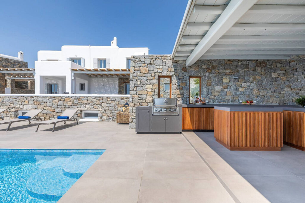 Modern kitchen next to the swimming pool in a splendid villa for rent in Mykonos, Greece.