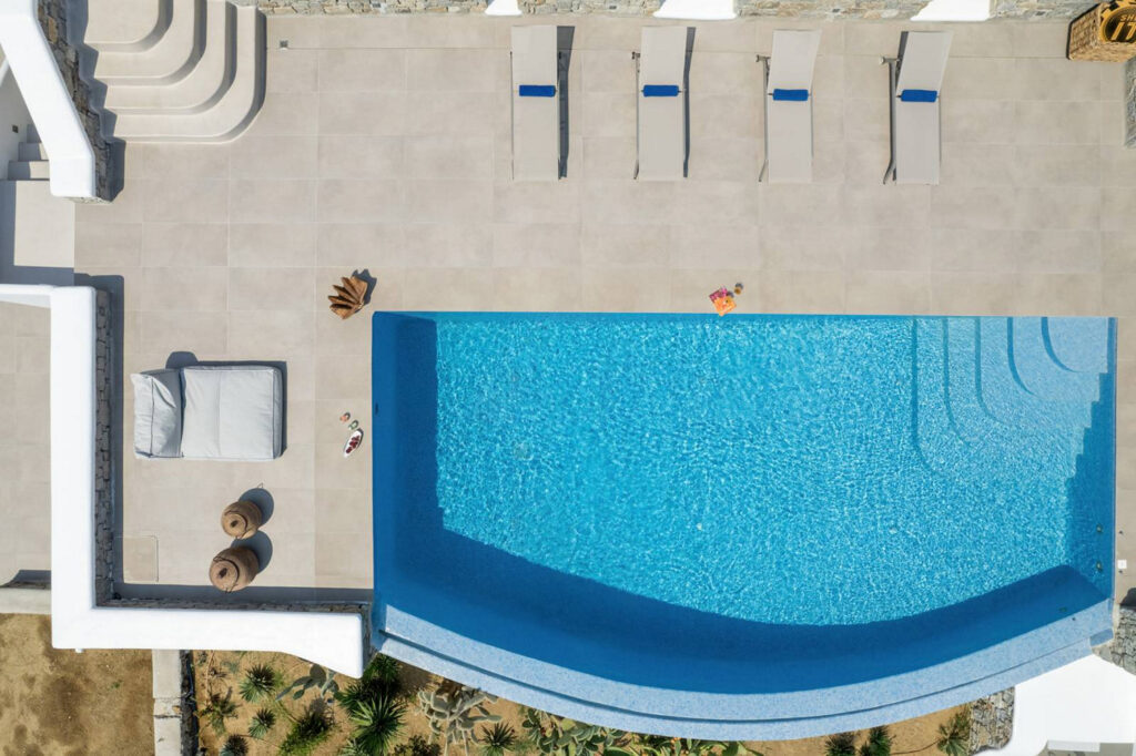 Modern swimming pool and beautiful yard at Mykonos lavish villa for rent.