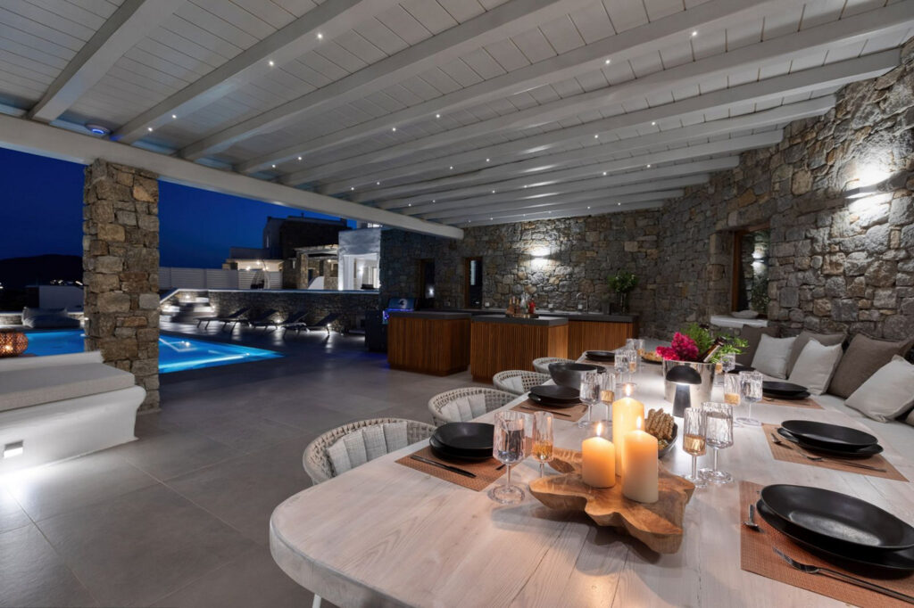 Dining outside space by the night in the best villa for rent, Mykonos, Greece.
