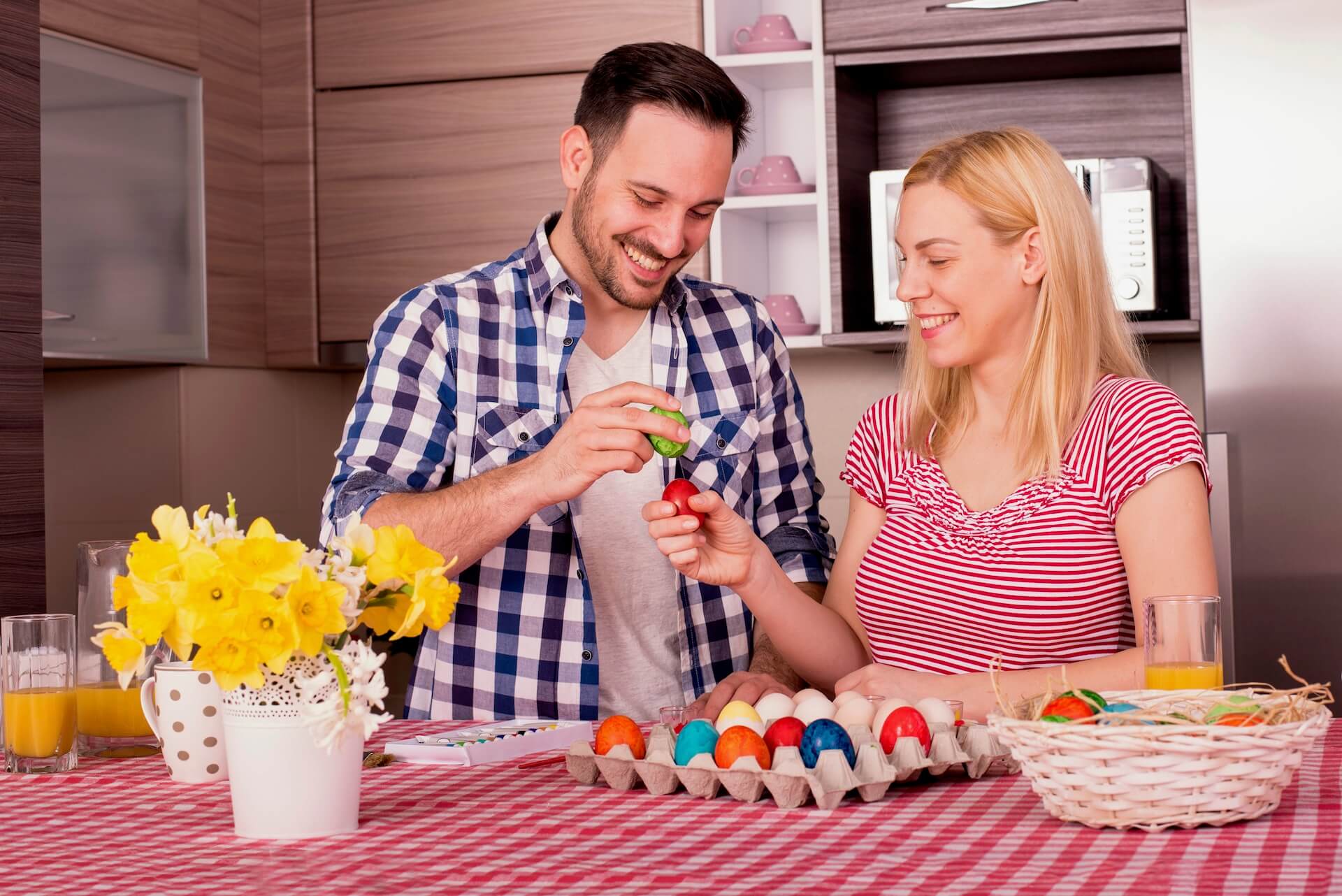 Man and woman cracking Easter eggs