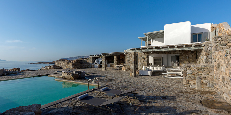 An opulent and lavish villa located in the picturesque island of Mykonos, offering panoramic views of the island and the sea. The villa boasts of a private pool and terrace, which are ideal for unwinding and relishing the Mykonos sunshine. The villa also comes with concierge services to ensure that your stay is as comfortable and delightful as possible.
