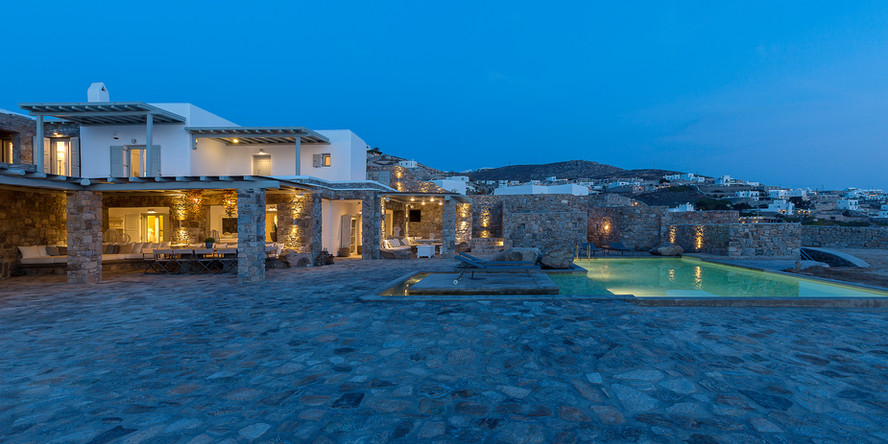 An opulent, upscale villa situated in the picturesque island of Mykonos, boasting panoramic views of the island and the sea. The villa is outfitted with a private pool and terrace, perfect for unwinding and taking in the Mykonos sunshine. Additionally, the villa offers concierge services to ensure that your stay is as comfortable and memorable as possible.