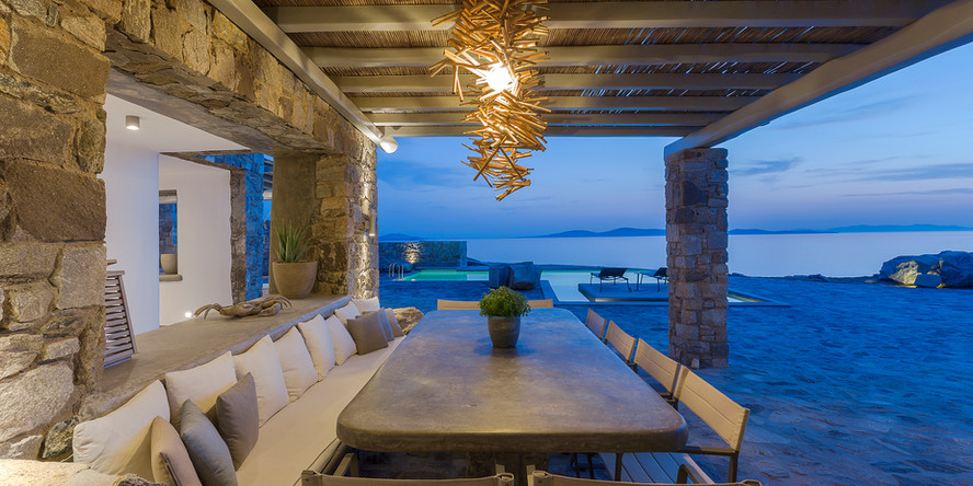 A luxury villa in Mykonos with a private pool and terrace, offering a panoramic view of the island and the sea. The interiors are beautifully designed with high-end furnishings and finishes, providing a comfortable and elegant atmosphere. The villa also offers concierge services to help make your stay as enjoyable as possible.