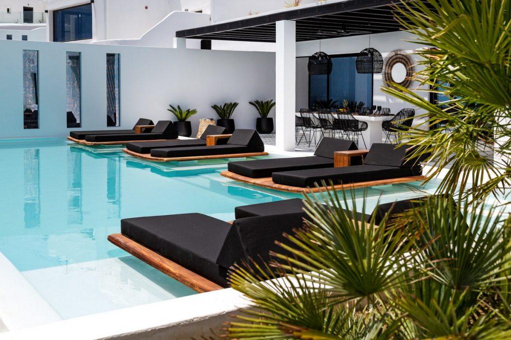 villas outdoor area with huge pool loads of comfortable sunbeds
