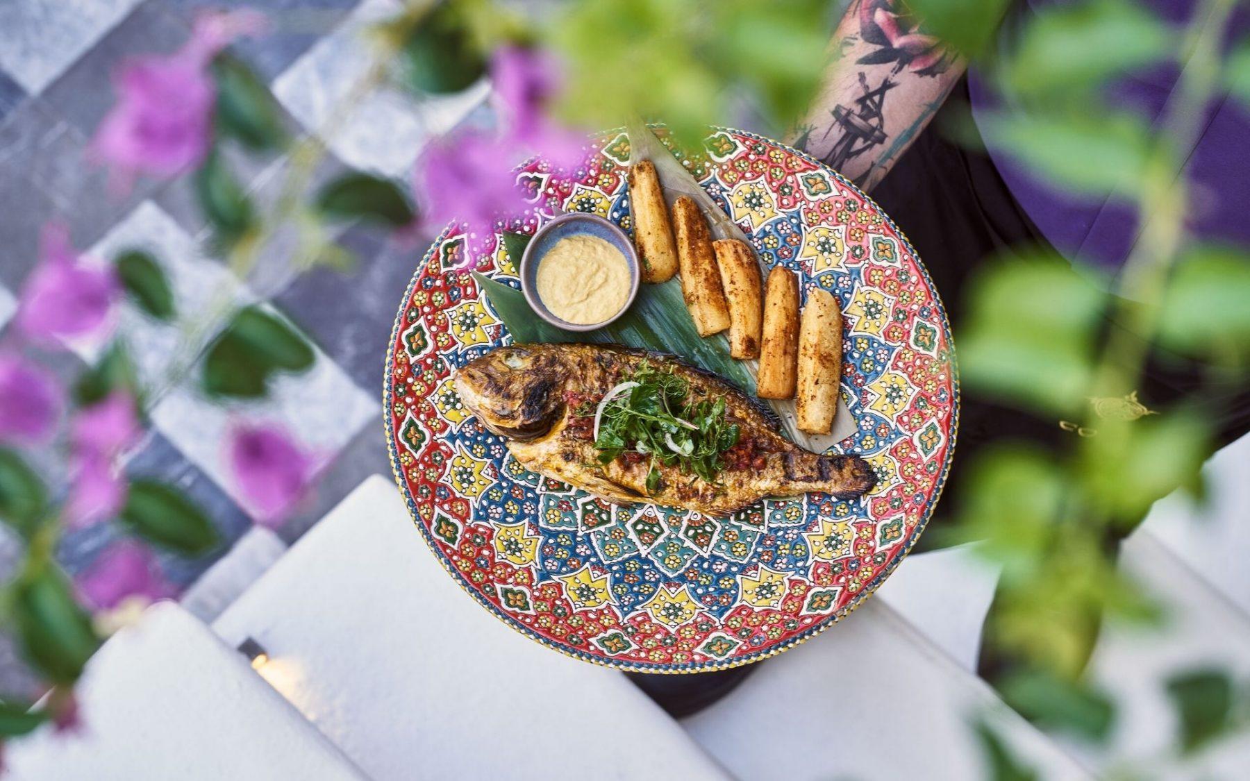 Fish served next to baked potatoes