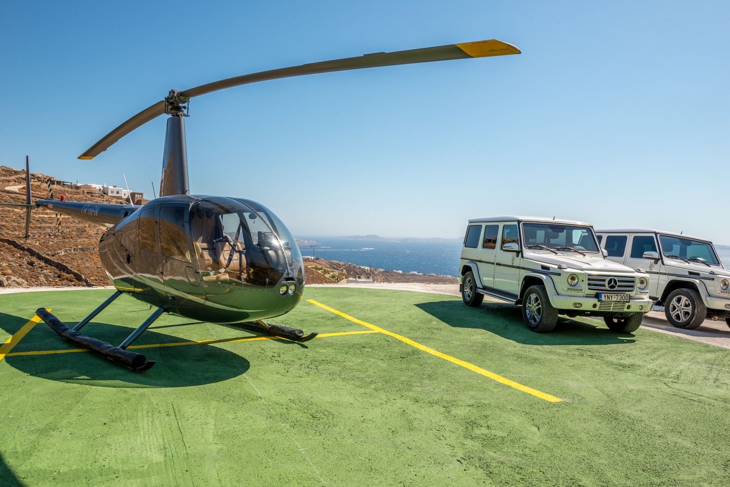 Helicopter and two Mercedes cars