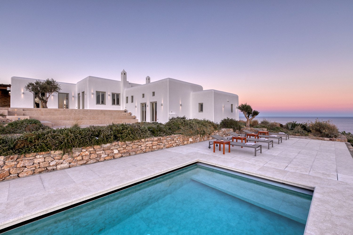 Pool, sunbeds, and a villa in Mykonos