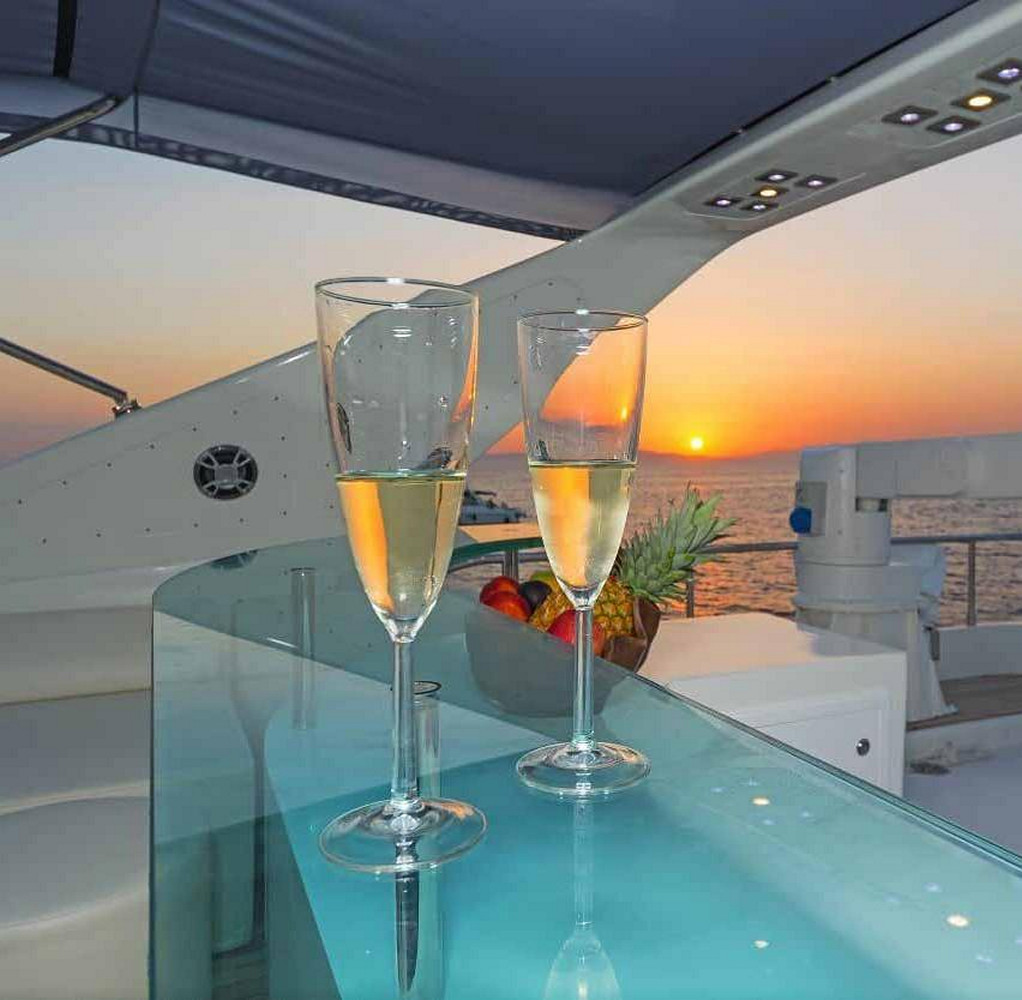Champagne glasses on a glass bar on the yacht near Mykonos 