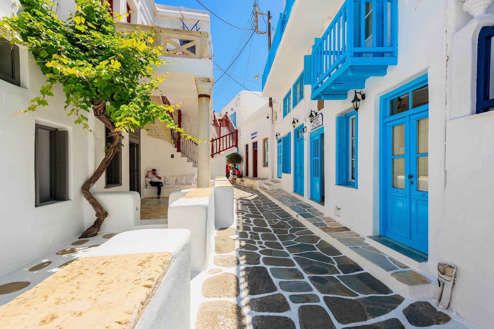 A street in Chora, and a tree on the left 