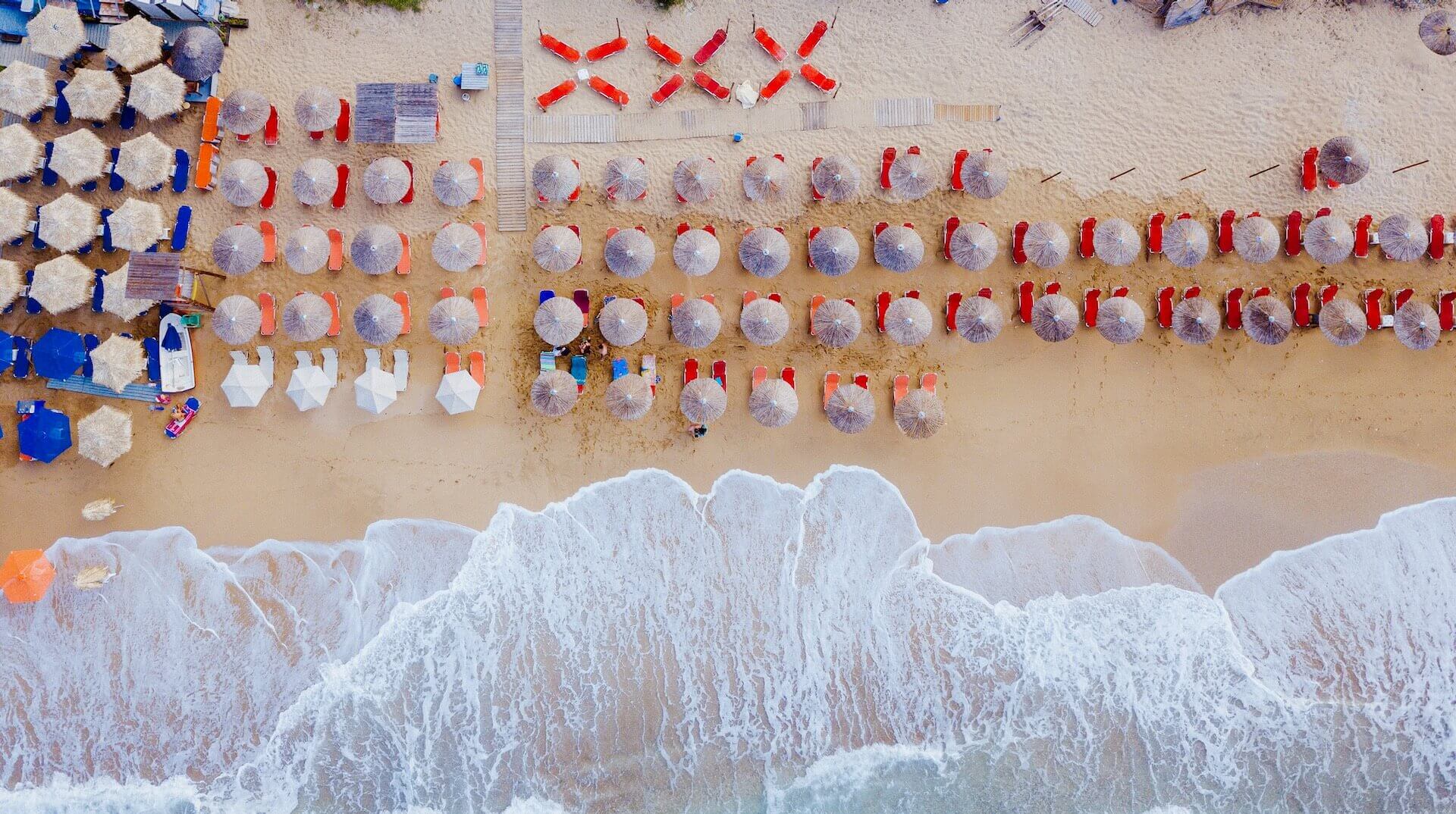 Beach with umbrellas and sunbeds on Mykonos