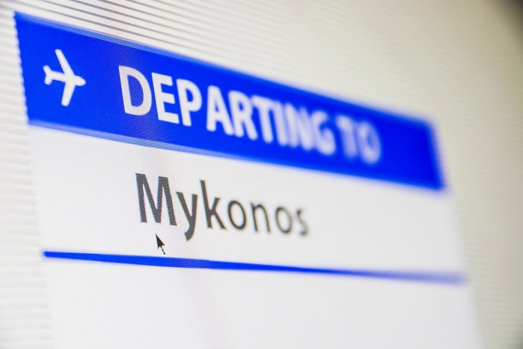 Computer screen with "departing to Mykonos" written on it