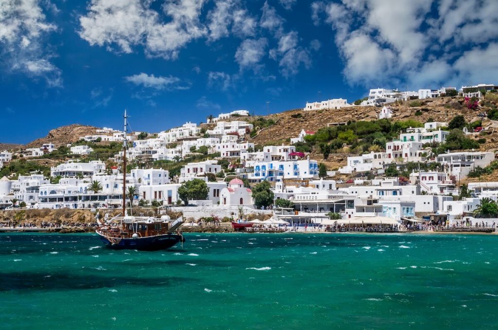 Houses and a boat on the coast of Mykonos town