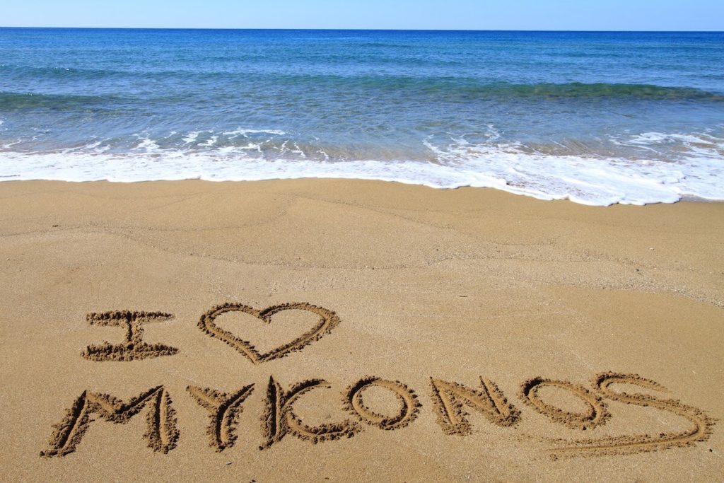 "I love Mykonos" written in the sand on the coast