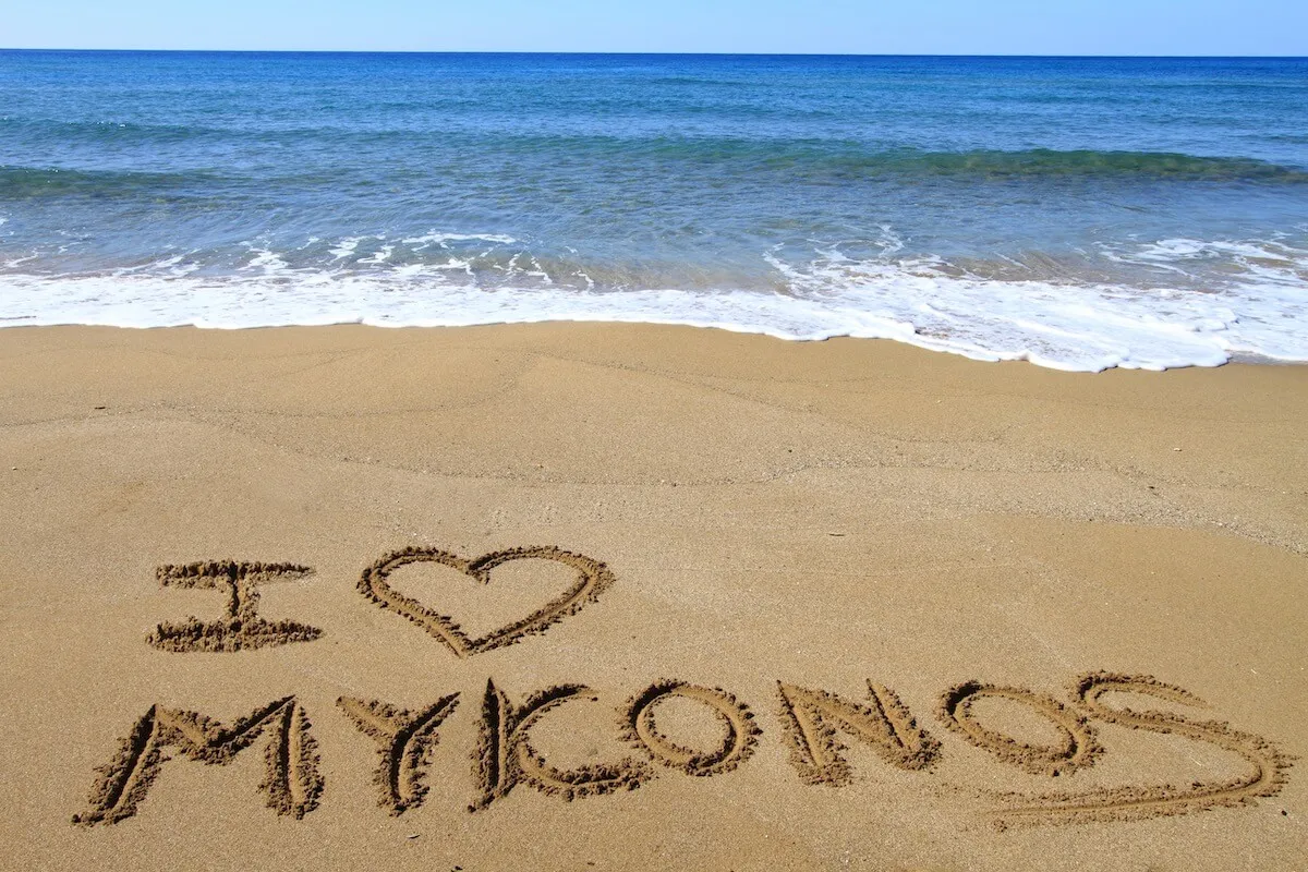  "I love Mykonos" written in the sand on the coast