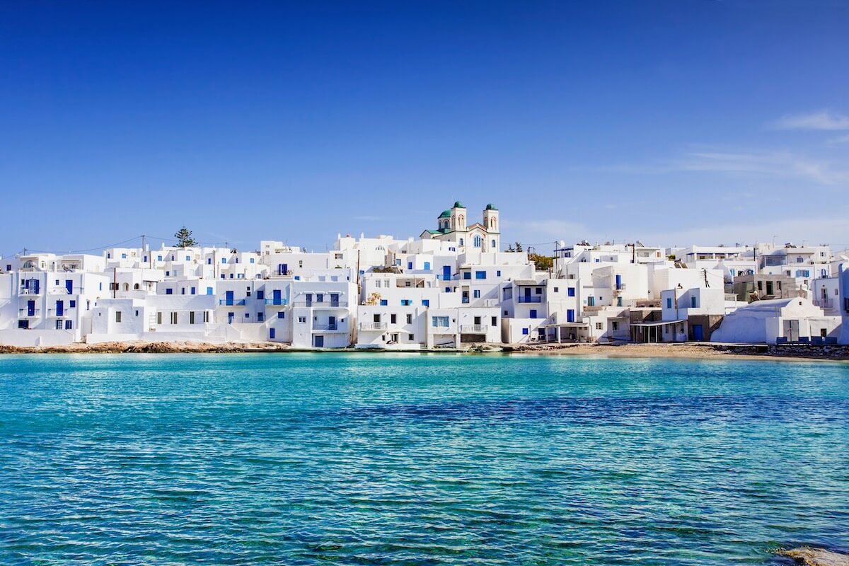 White houses on the coast of Mykonos viewed from the sea