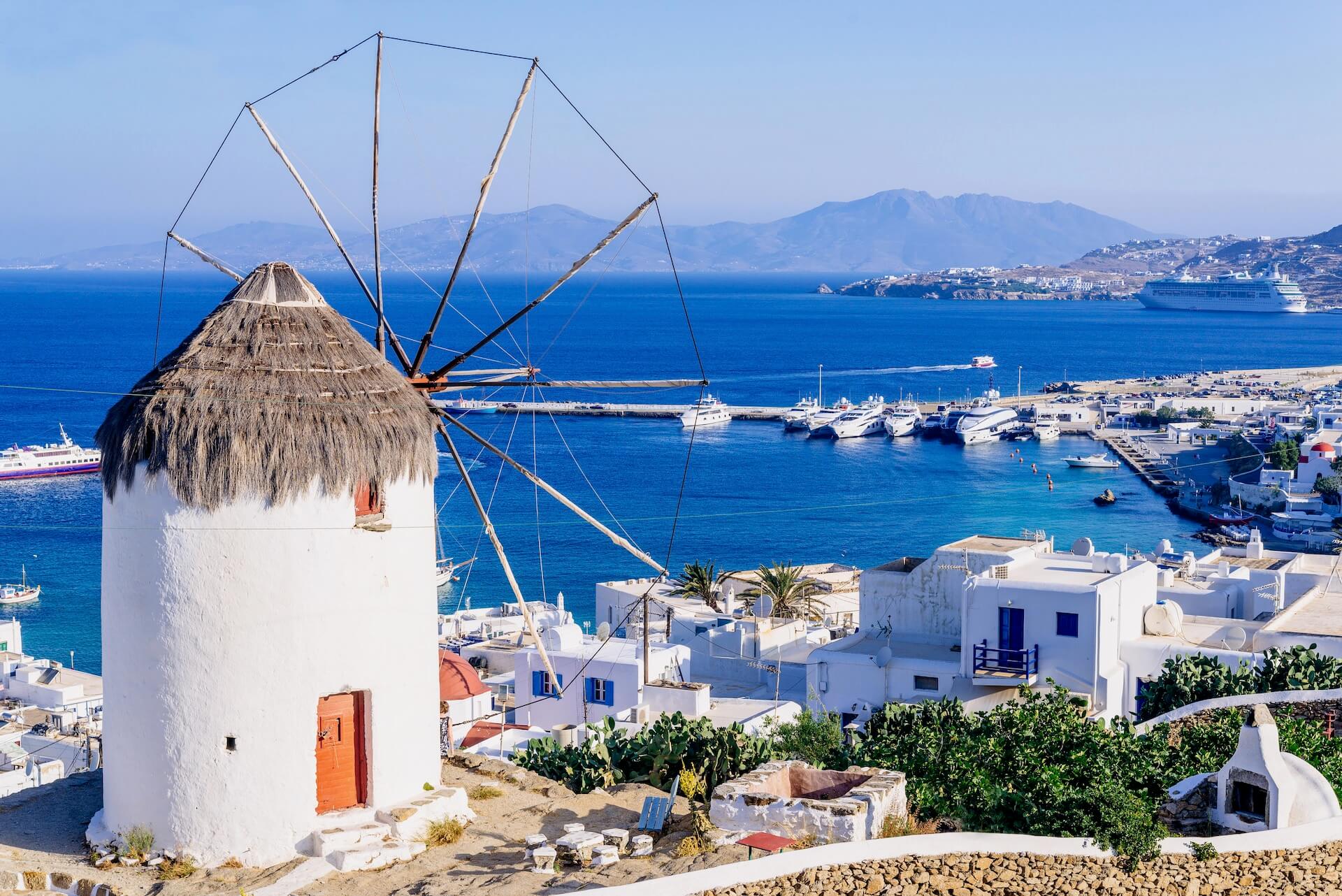 The windmill in Mykonos town, and port and ferries in the distance