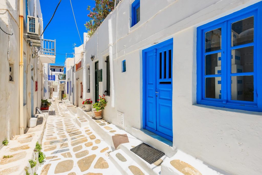 Narrow street with white houses in Mykonos town