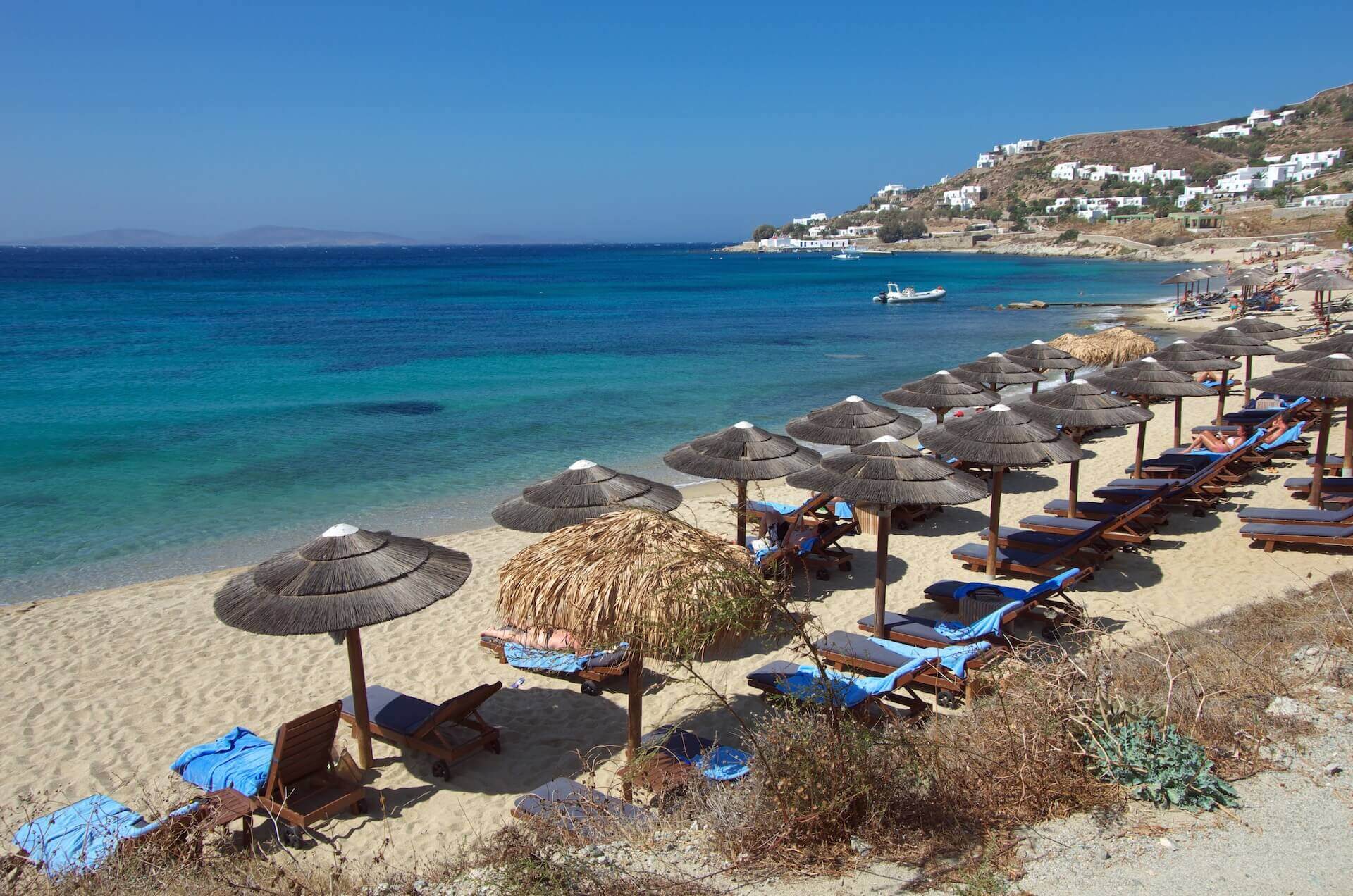 View of the sunbeds and umbrellas on the coast of Mykonos