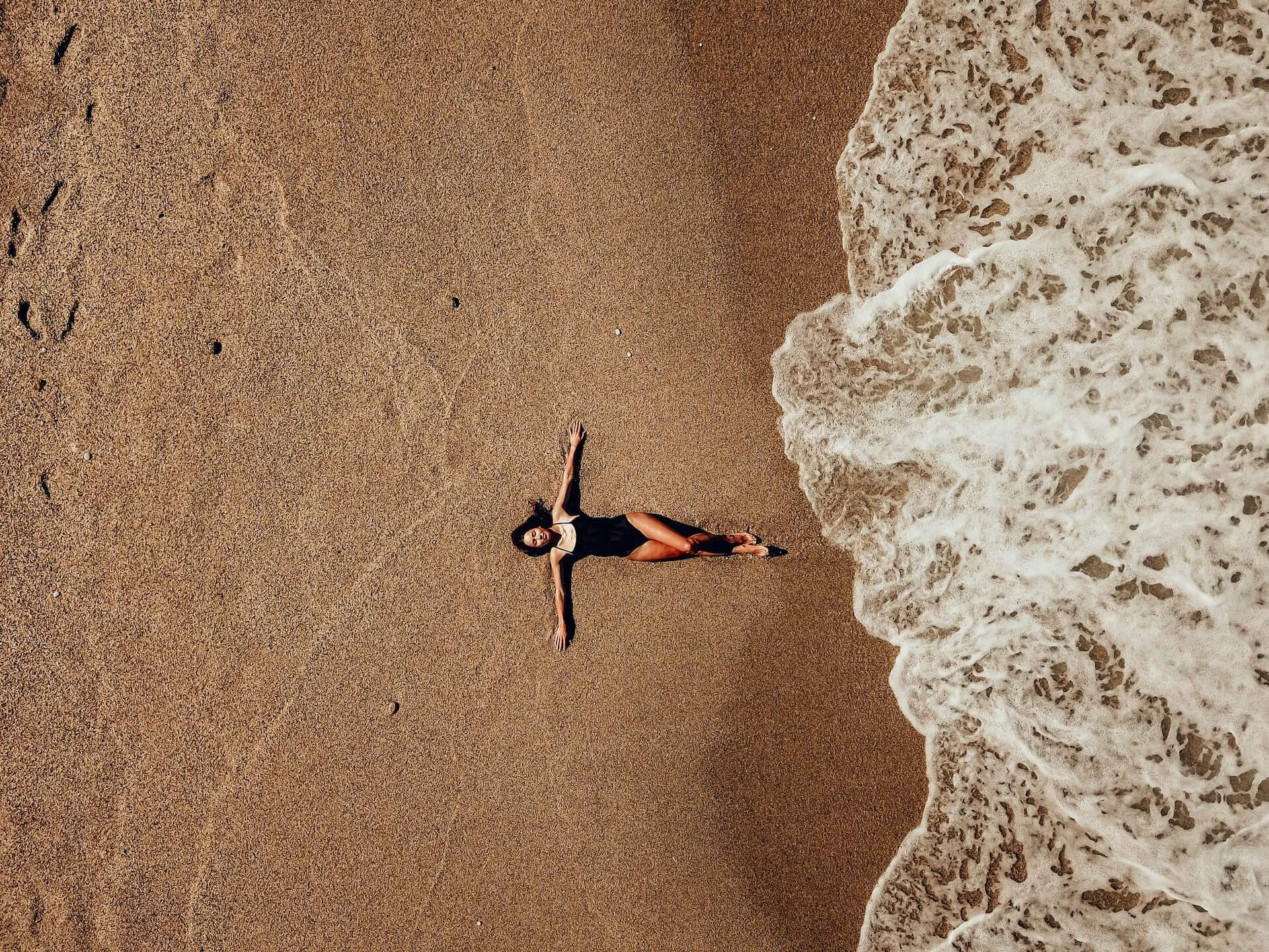 Woman on a secluded beach in Mykonos relaxing