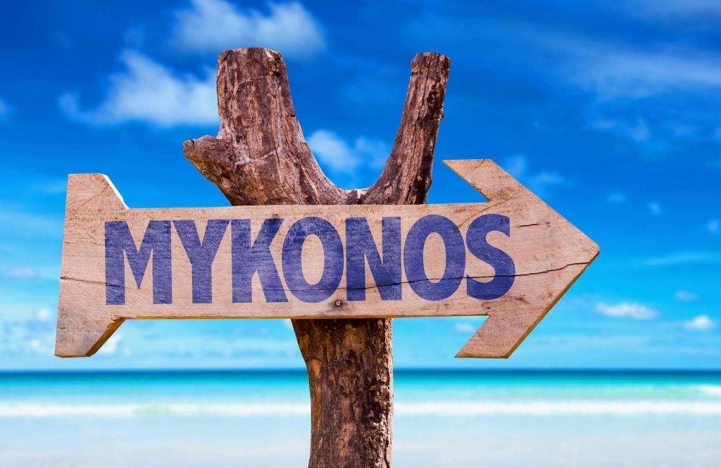 Wooden road sign showing Mykonos