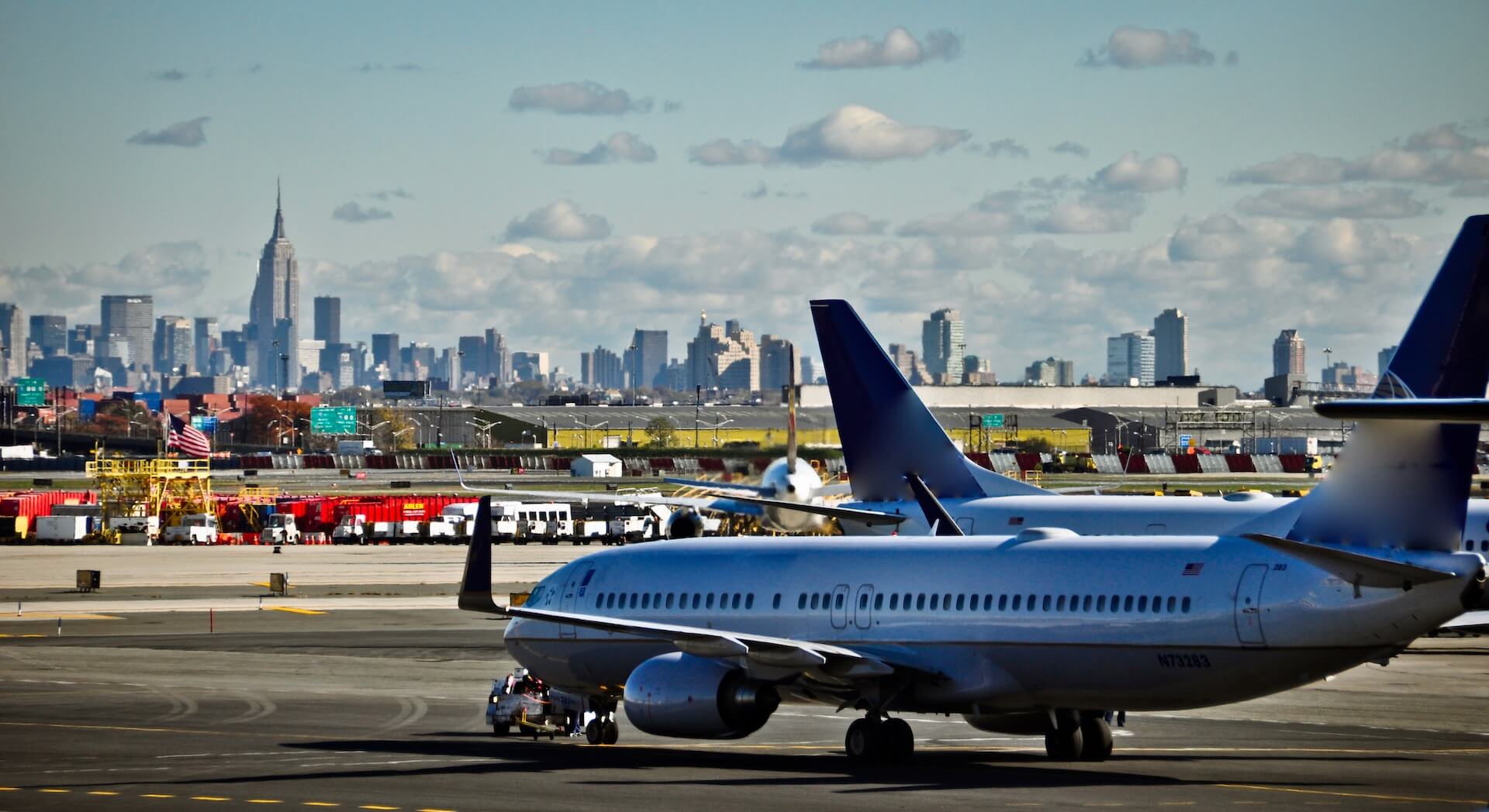An airplane on the runway and Manhattan in the distance