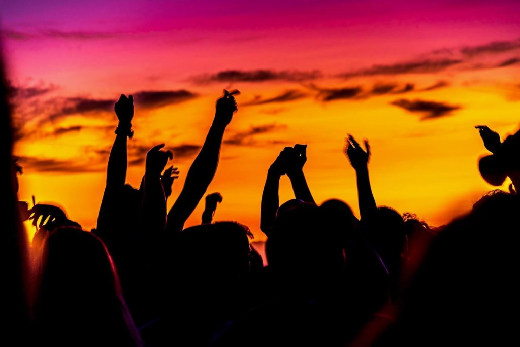 Crowd dancing during the sunset
