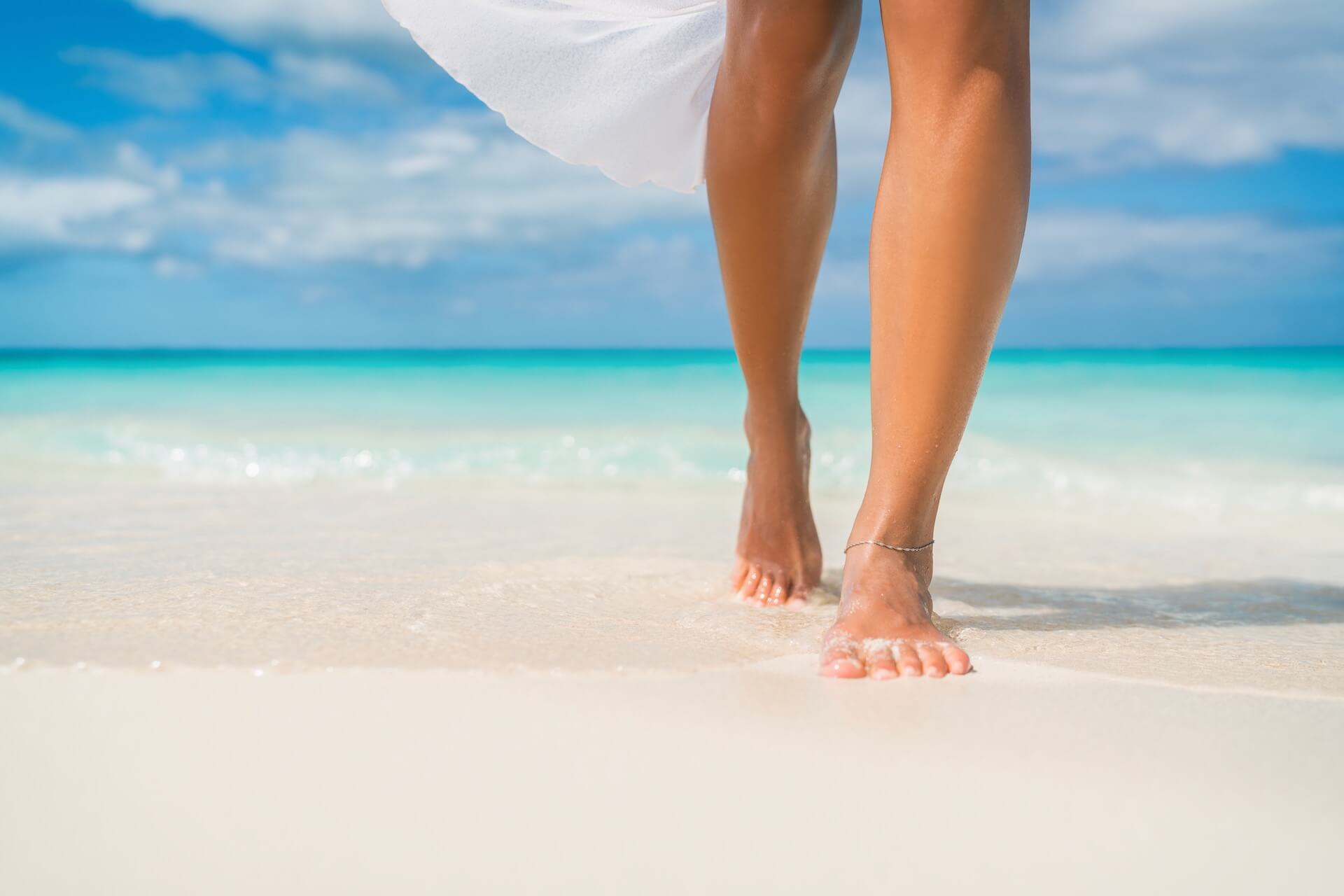 Woman's legs on the sand