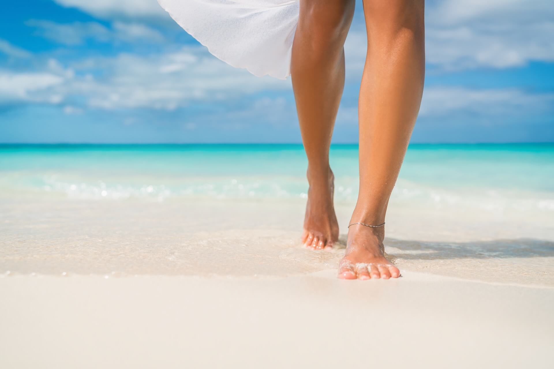 Woman's legs on the sand