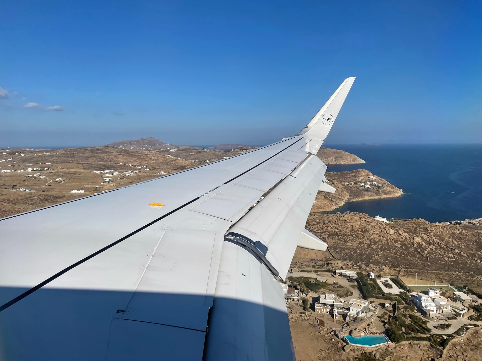 Wing of the plane flying over Mykonos