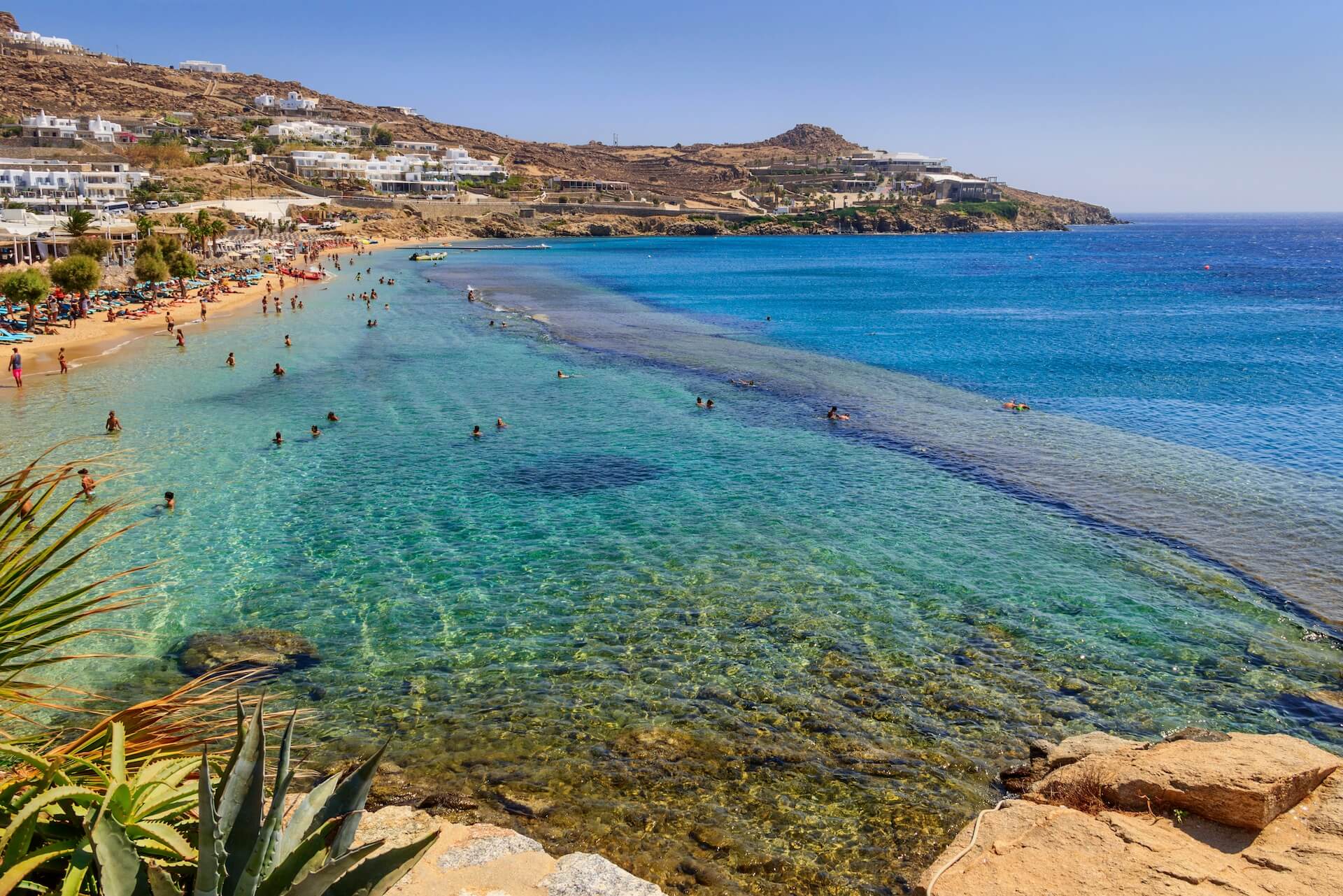 View of the beach in Mykonos full of people 