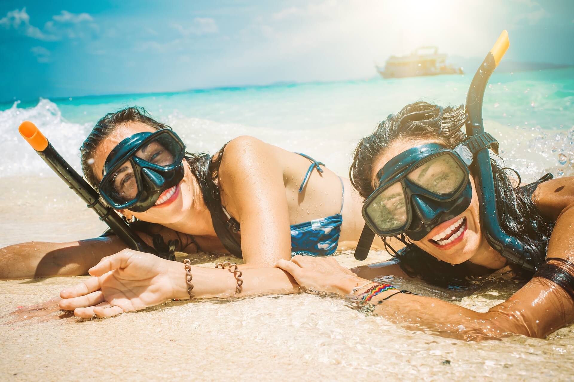 Girls with snorkeling gear on a beach