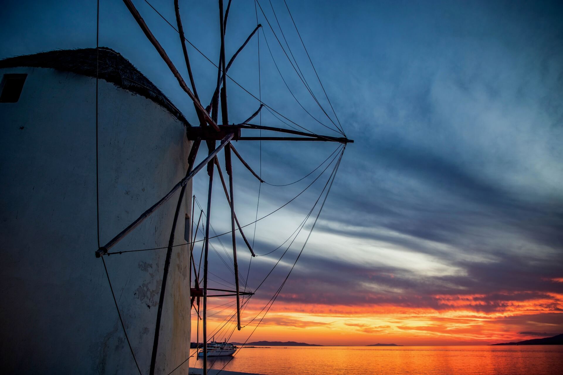 Sunset and a windmill on the coast of Mykonos
