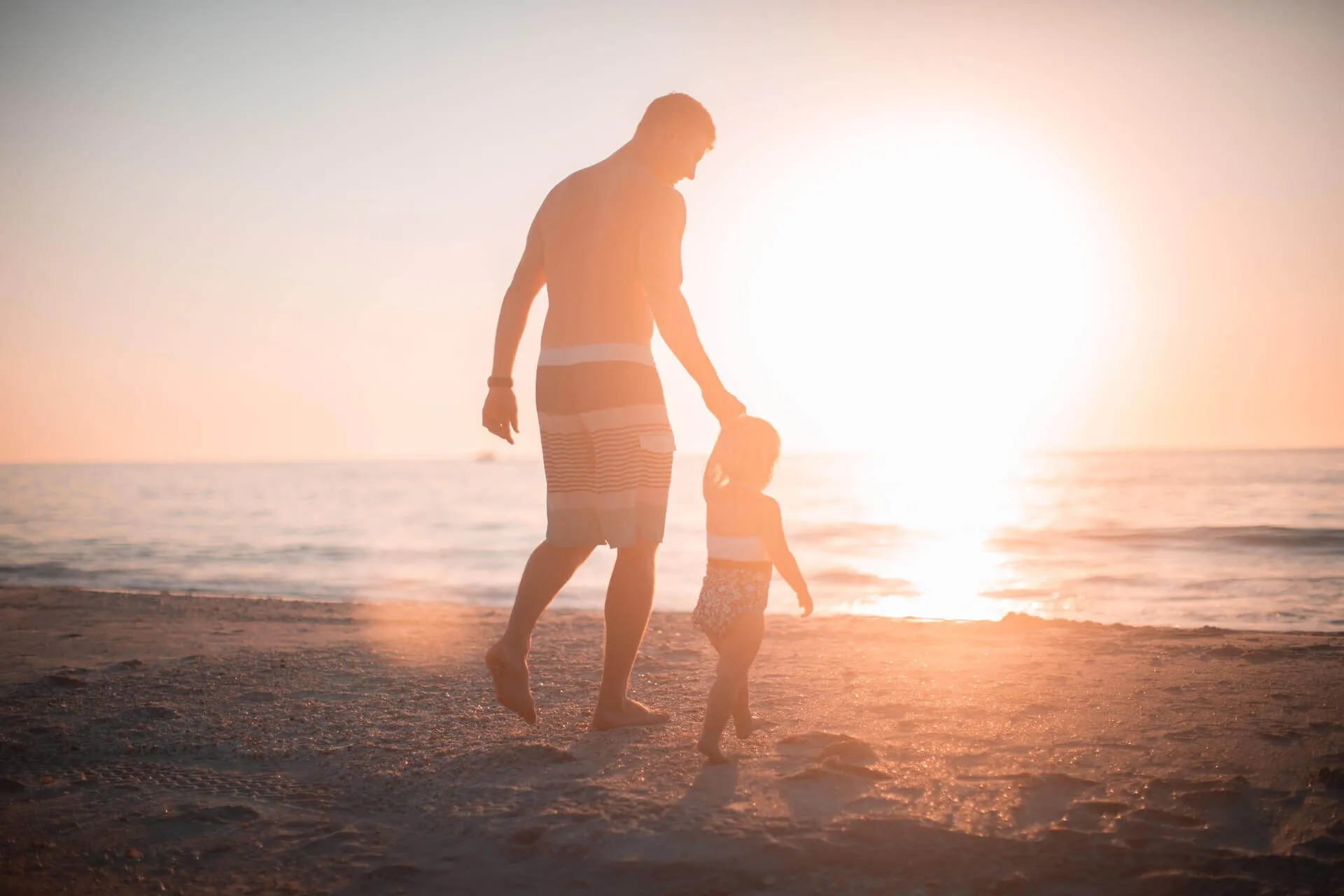 Father with a daughter on the beach