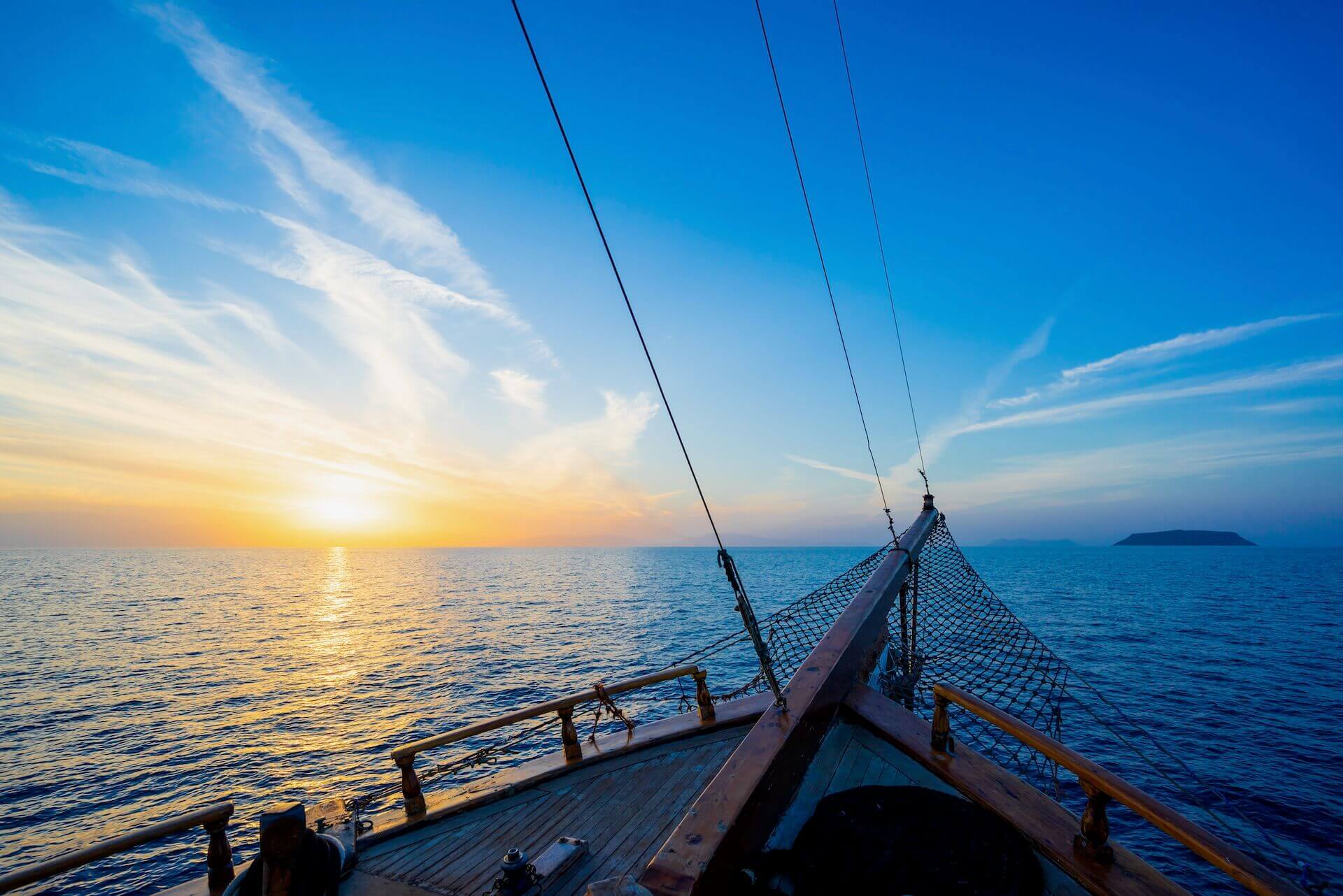 Wooden deck of a boat at sunset in waters near Mykonos