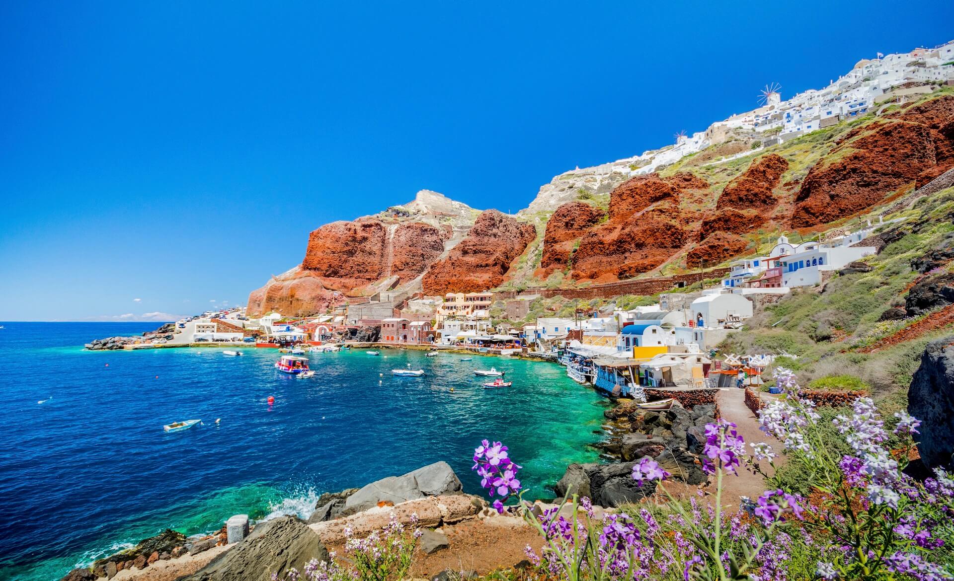 A view of a beautiful cove with colorful homes and small boats on the sea