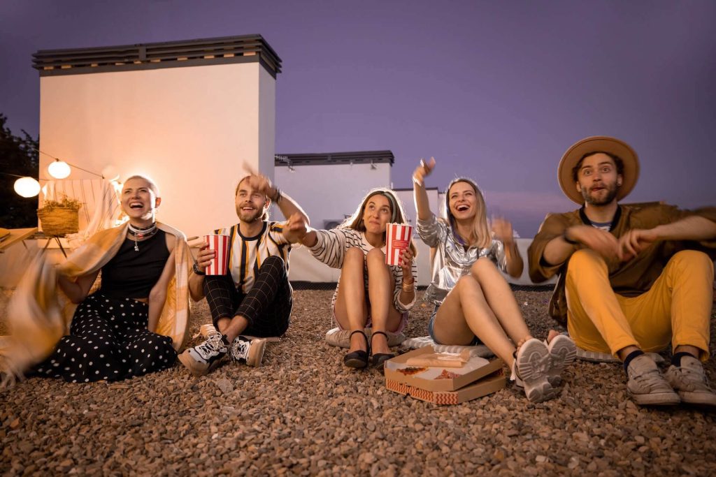 Friends enjoying watching a movie in the open-air movie theater
