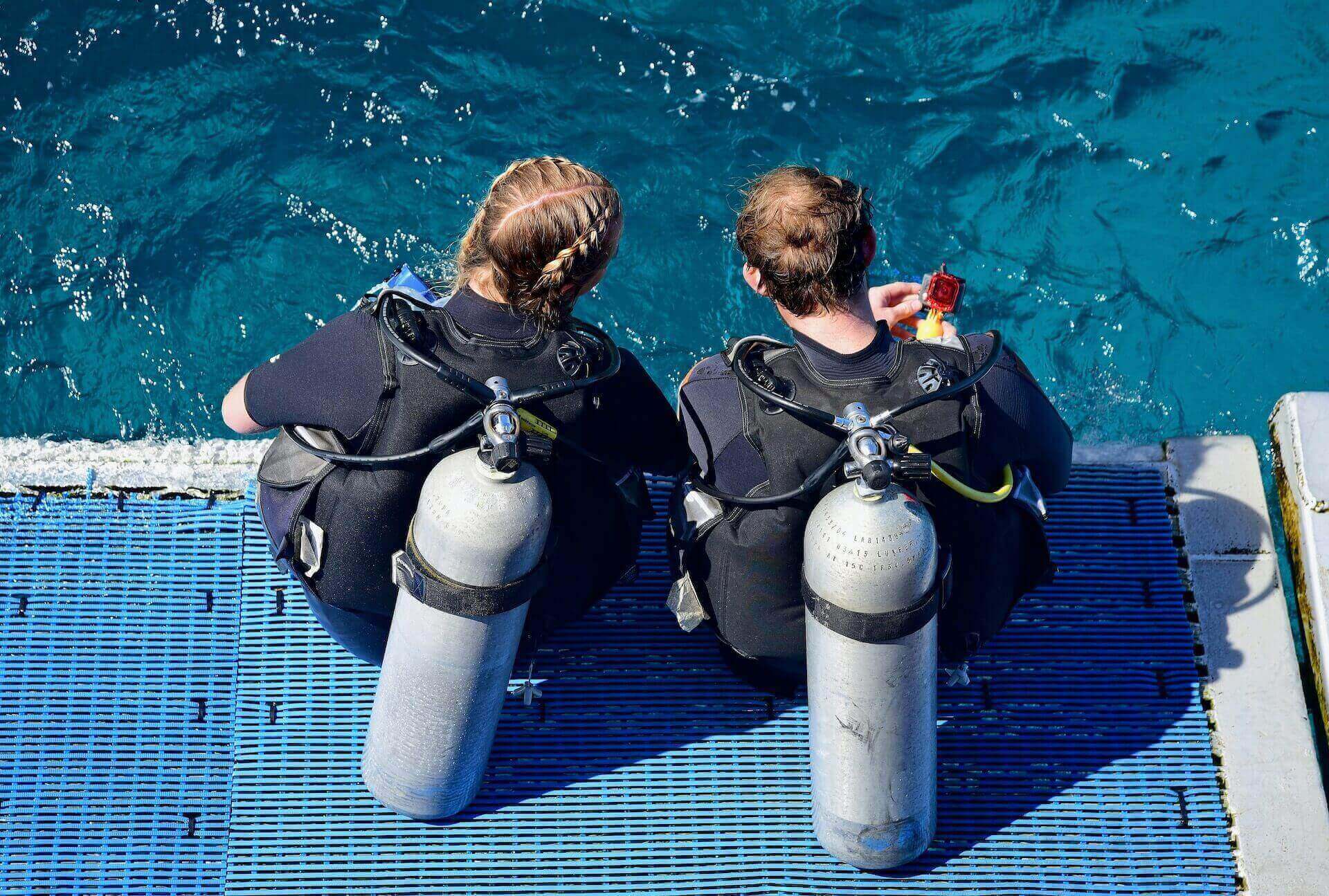 A boy and a girl getting ready to jump in the water