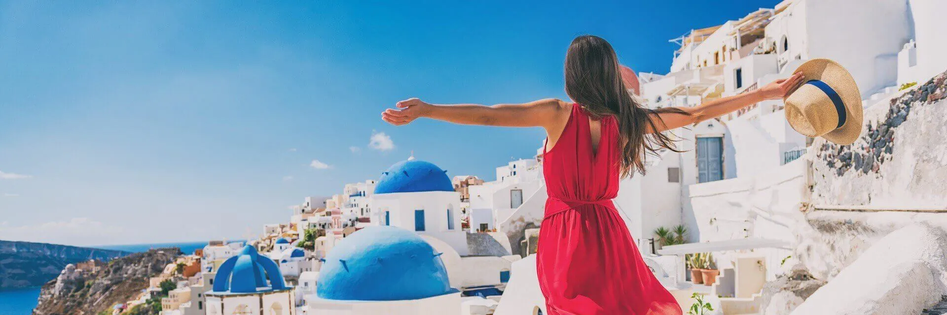 Girl in a pink dress on Santorini