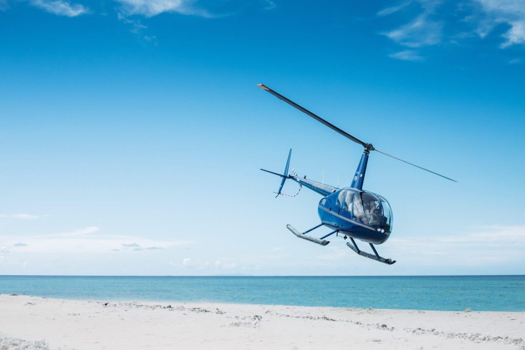 A helicopter flying above a beach