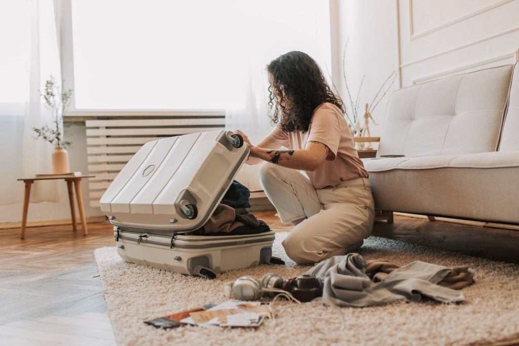 Woman packing a suitcase for travel
