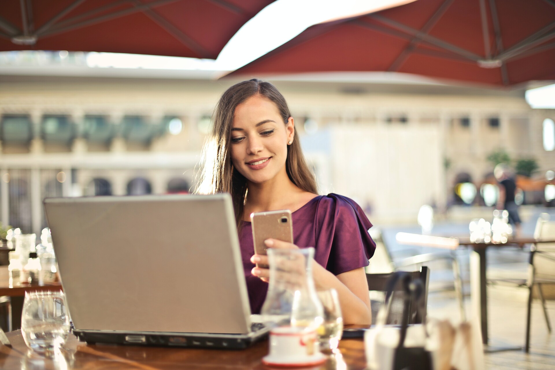 Woman working on a laptop from a restaurant 