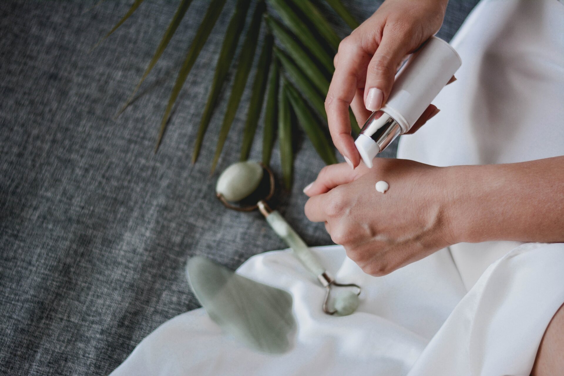 Woman putting cream on her hand