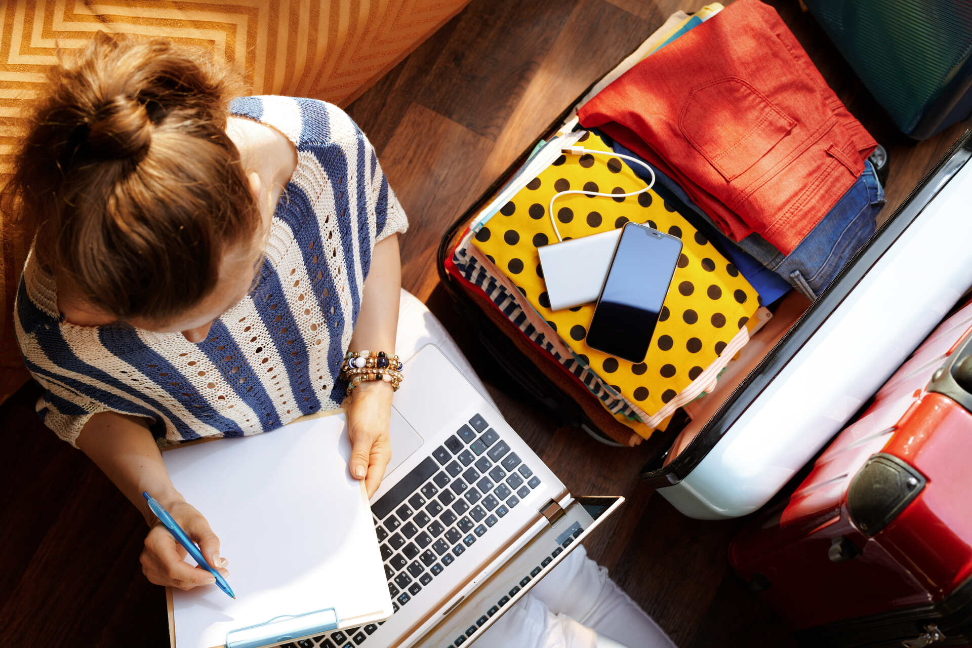  Woman sitting next to an open suitcase