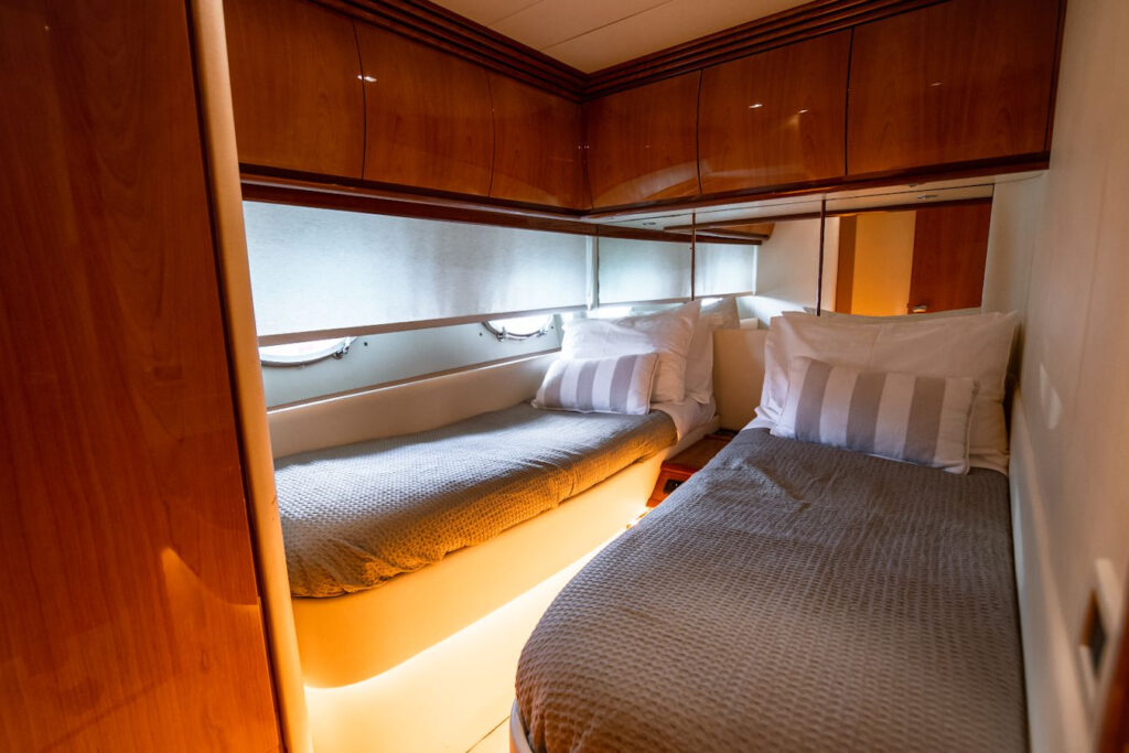 luxurious and spacious interior of a yacht, featuring elegant furnishings and comfortable seating areas. The yacht is docked in Mykonos, surrounded by the beautiful Mediterranean sea and offers concierge services to ensure a comfortable and enjoyable sailing experience.