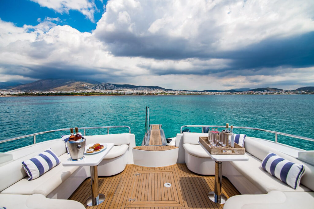 A luxurious yacht with a modern design and elegant furnishings, features a flybridge and upper deck, perfect for entertaining guests, enjoying the beautiful view of Mykonos Island and the Mediterranean sea. Concierge services are provided to ensure a comfortable and enjoyable sailing experience.